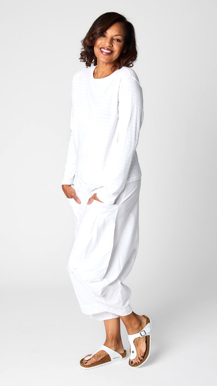 Model wearing "chalk" white monochrome striped long sleeve tee with white cropped double pocket pant in tencel cotton.