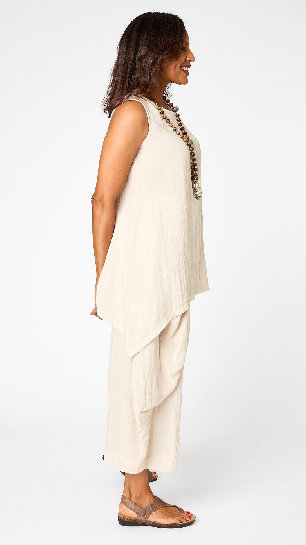 Model wearing cloud layer tank, and cloud double pocket pant with brown leather sandal.