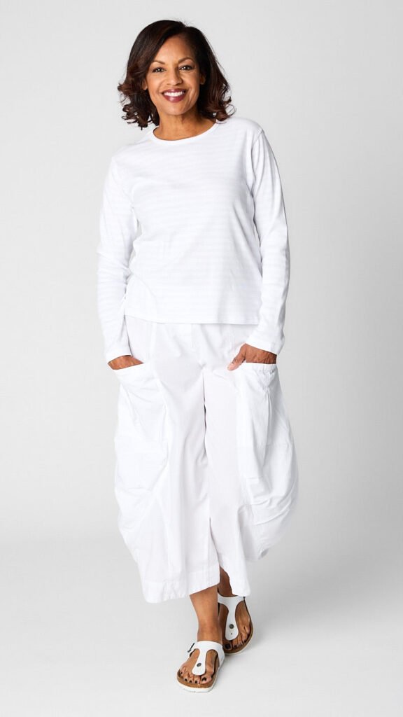 Model wearing "chalk" white monochrome striped long sleeve tee with white cropped double pocket pant in tencel cotton.