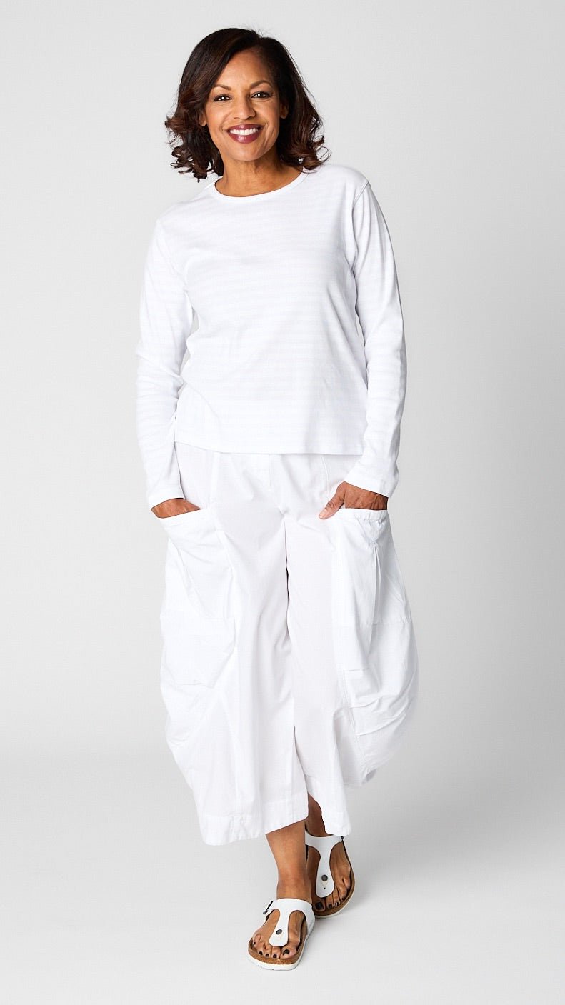 Model wearing "chalk" white monochrome striped long sleeve tee with white cropped double pocket pant in tencel cotton.